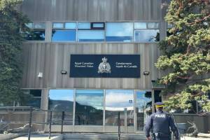 An RCMP officer heads toward the doors of the RCMP detachment in Whitehorse on May 5, 2025.