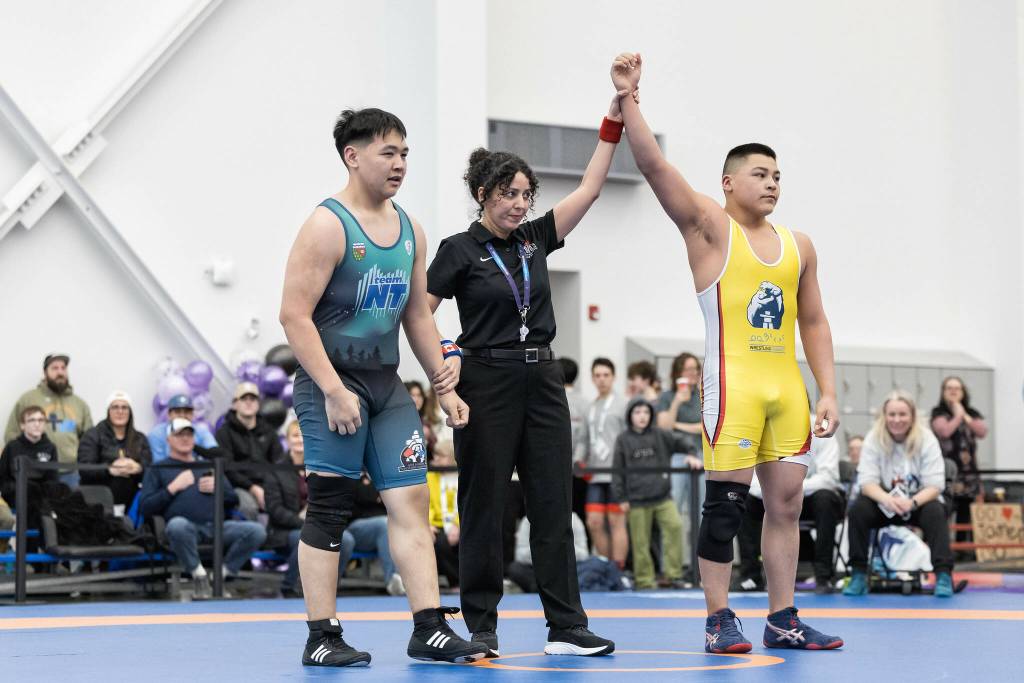 Chael Sammurtok, right, is declared winner of his match over a Northwest Territories opponent. Sammurtok won a gold ulu in the male under 85 kg (187 lbs) individual wrestling competition on Day 4 of the Arctic Winter Games in Whitehorse. Photo courtesy Thorsten Gohl